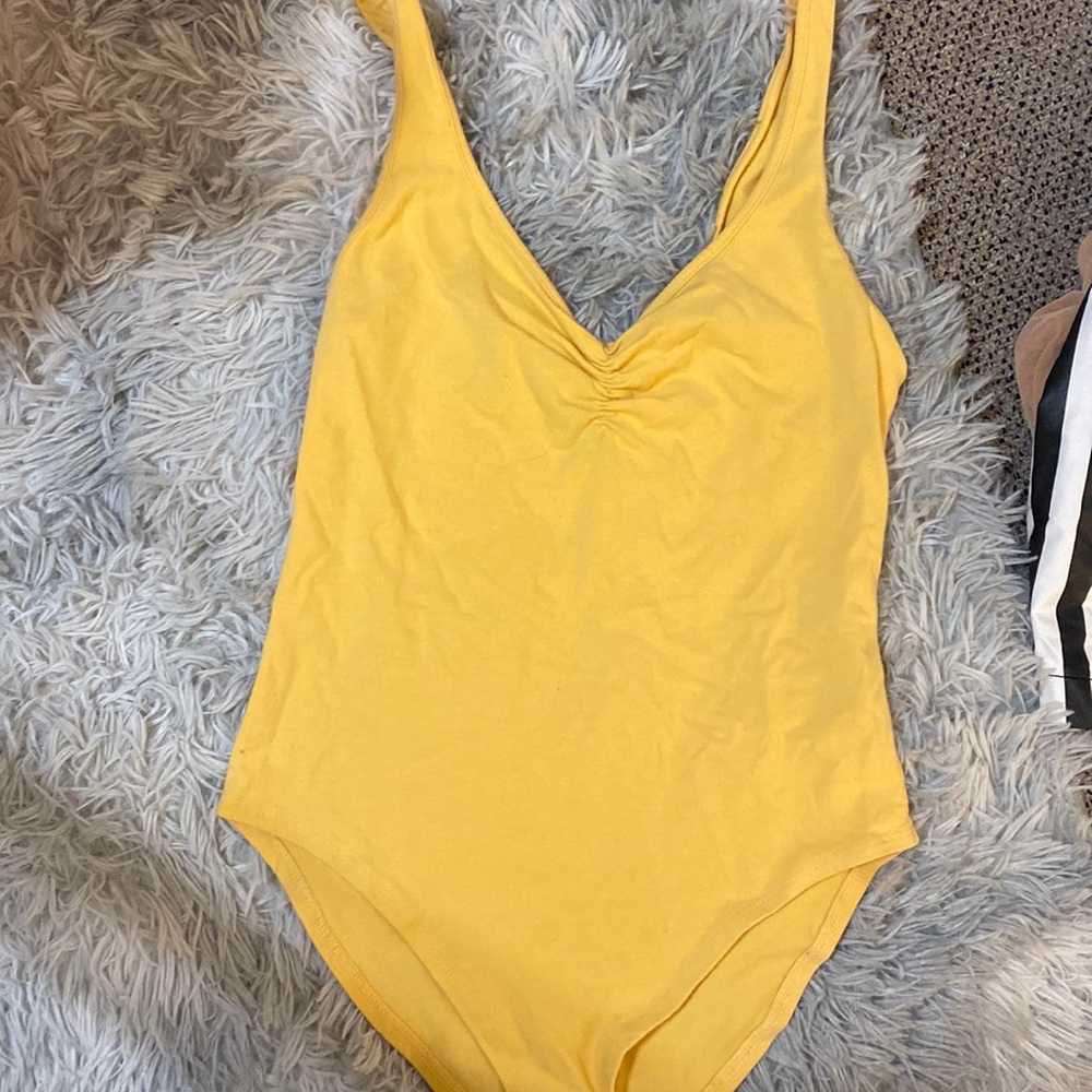 Pastel yellow body suit